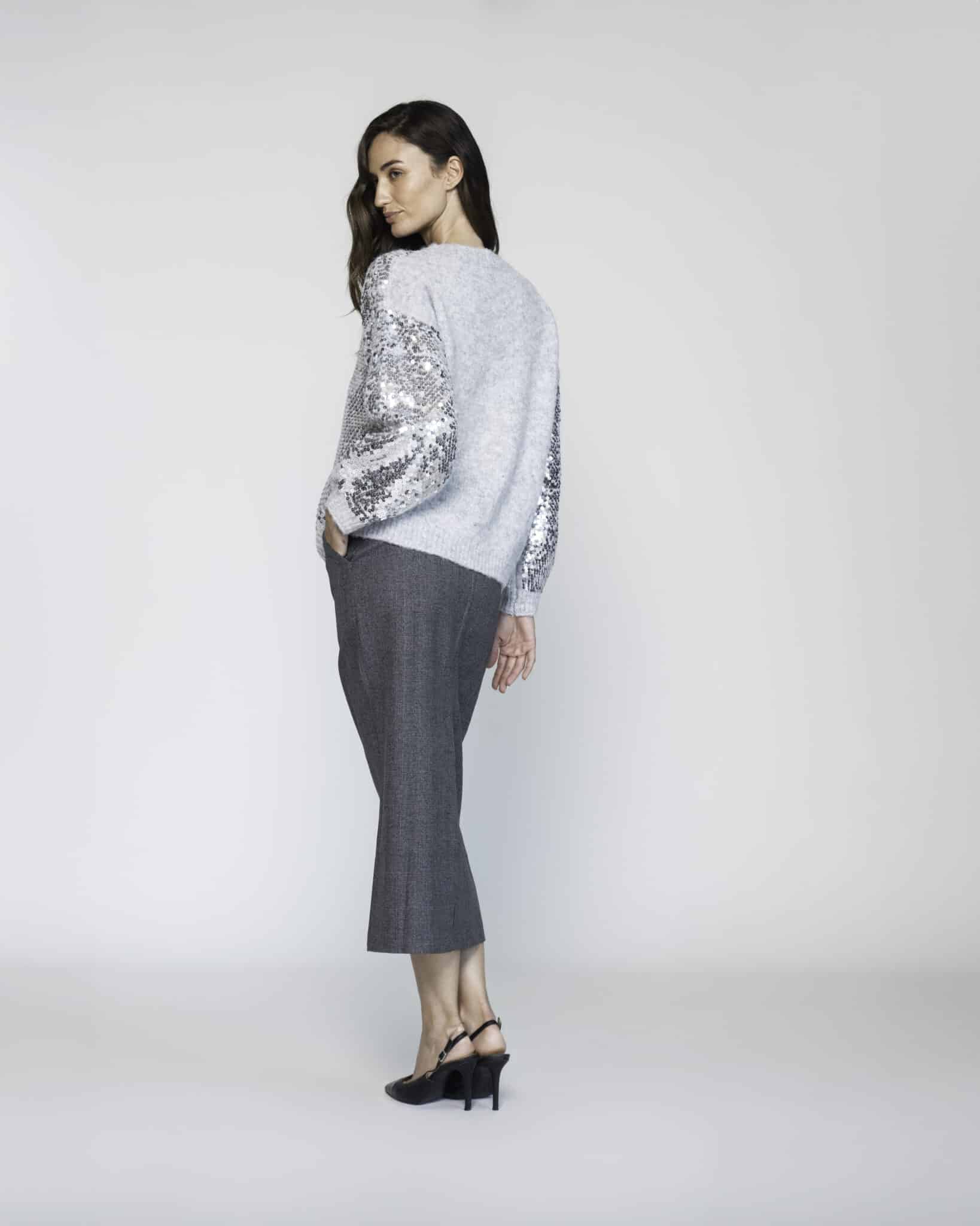 Sweater gris con mangas de lentejuelas plateadas, modelo Formentera, frente.